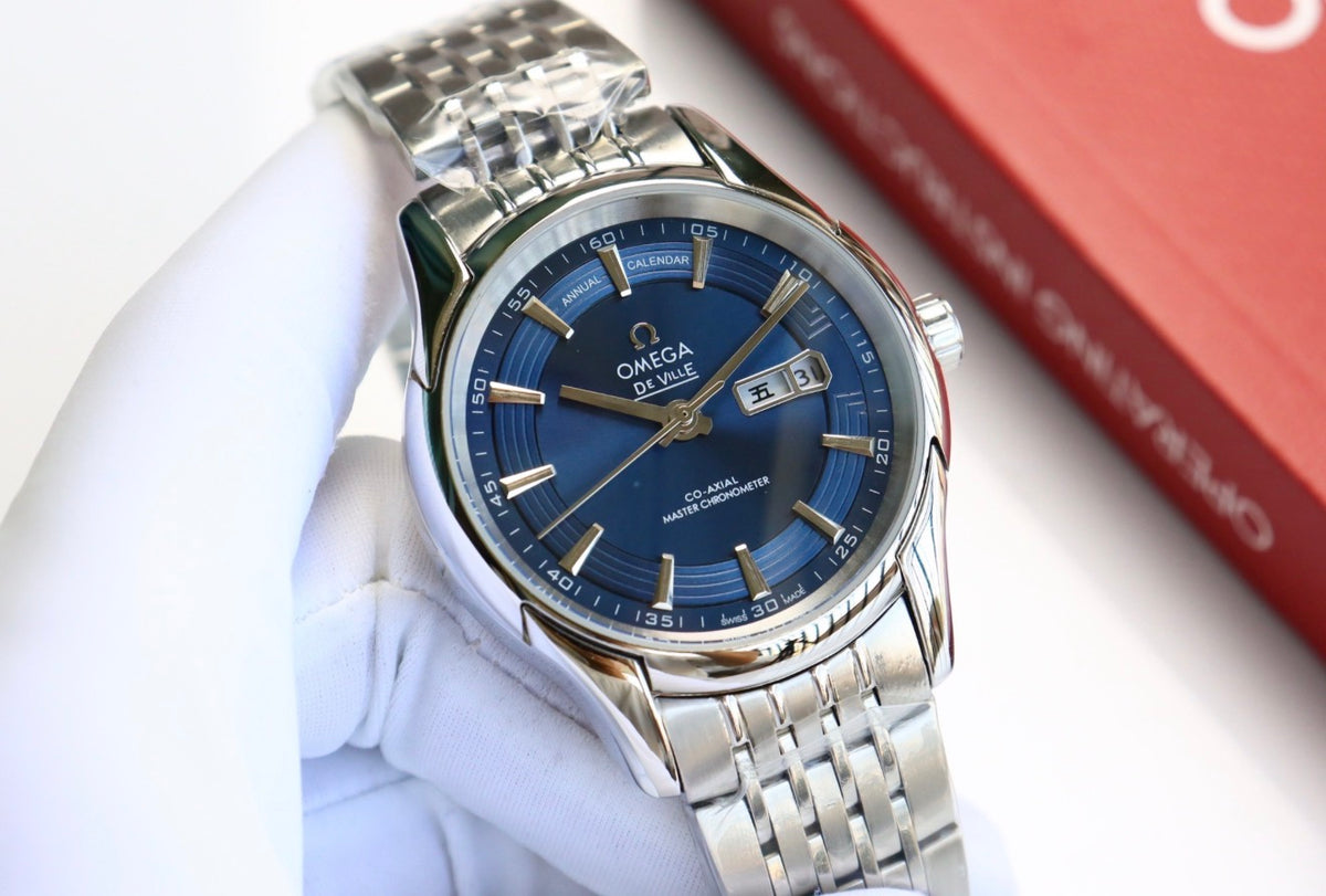 Reloj de pulsera OMEGA De Ville Hour Vision con esfera azul y calendario anual.