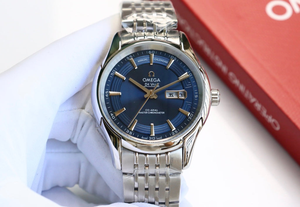 Reloj de pulsera OMEGA De Ville Hour Vision con esfera azul y calendario anual.