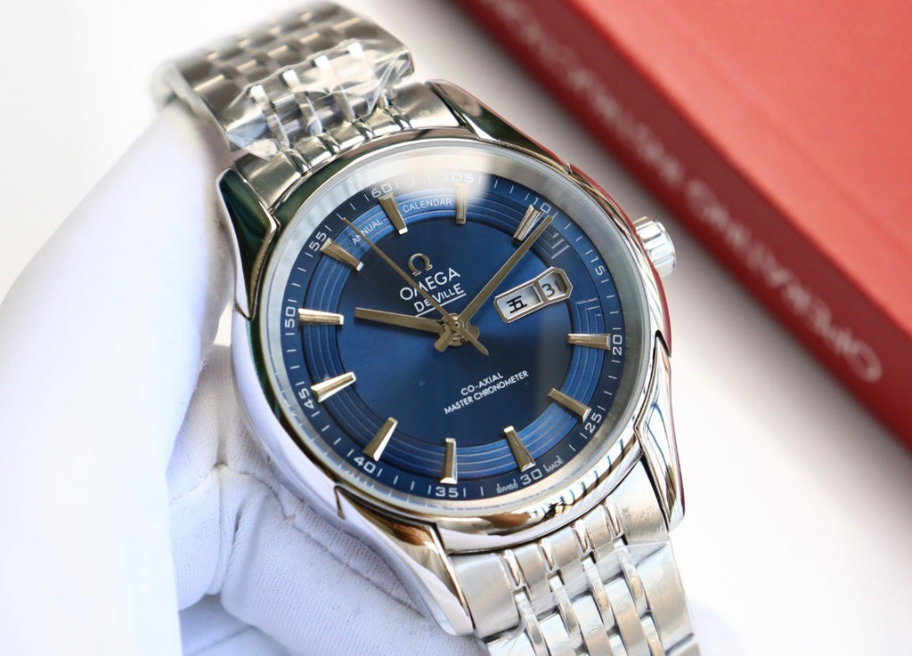 Reloj de pulsera OMEGA De Ville Hour Vision con esfera azul y calendario anual.
